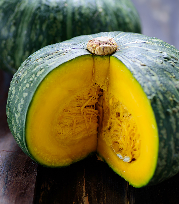Green pumpkins on wooden background, organic vegetable